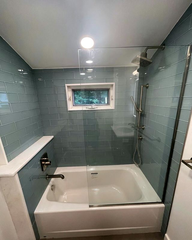 Bathroom with blue-gray glass tile and soaking tub