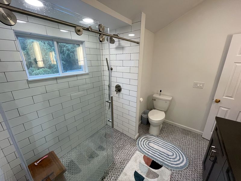 Subway tile shower with sliding glass door