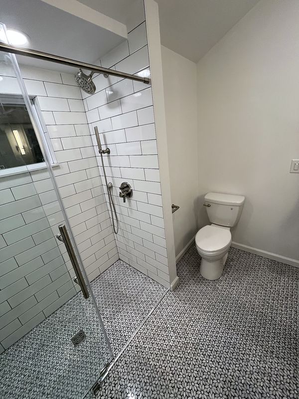 Frameless glass shower with pebble floor