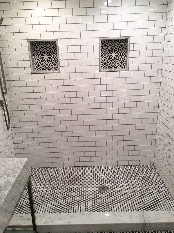 White subway tile shower with recessed niches