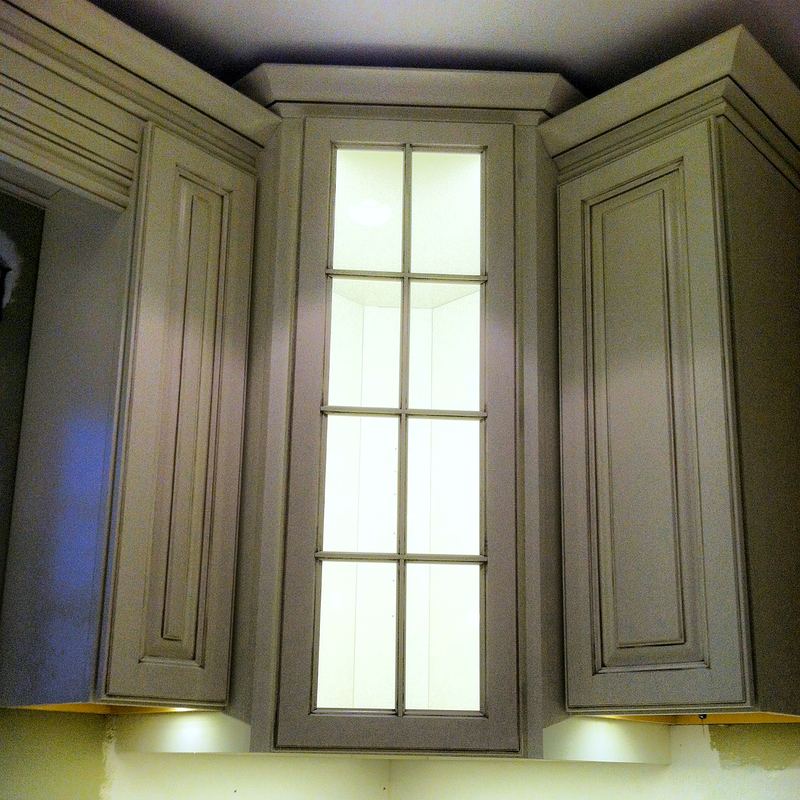 Custom cabinetry with lit glass display
