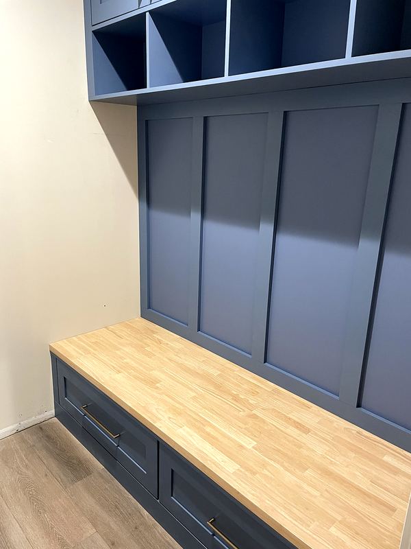 Custom mudroom lockers in navy with butcher block bench