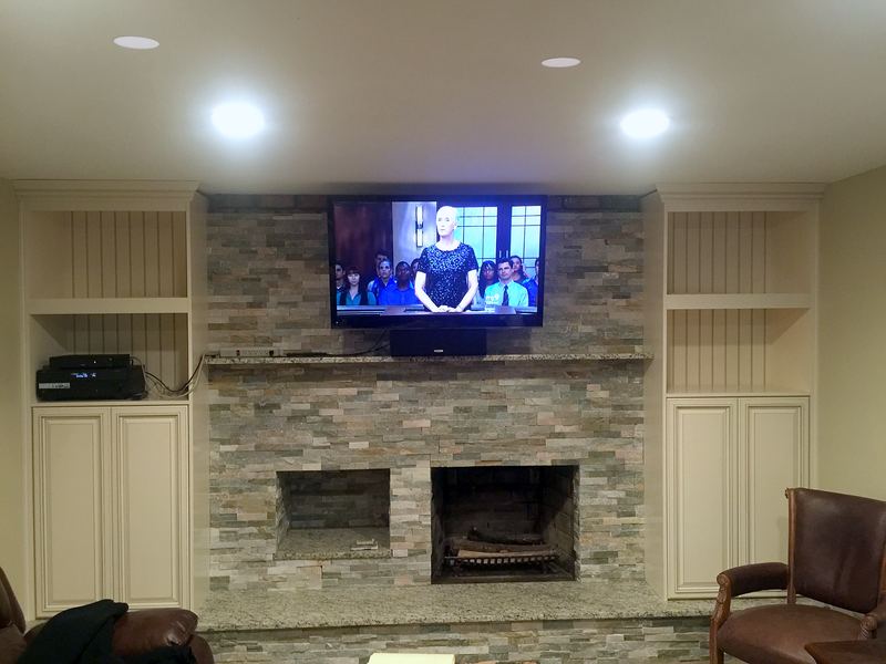 Stacked stone fireplace with built-in media cabinets