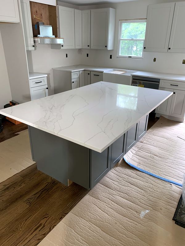 Gray kitchen island with white marble-look quartz