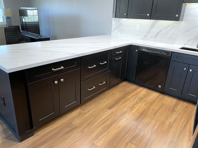 Black shaker cabinets with white marble-look quartz