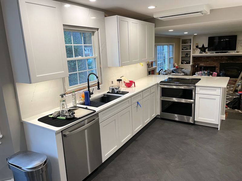 White kitchen with quartz countertops and stainless appliances